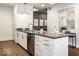 Modern condo kitchen with stainless steel dishwasher and white cabinetry, perfect for cooking and entertaining at 622 E 10Th St # 212, Indianapolis, IN 46202