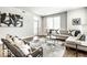 Comfortable living room with hardwood floors, large windows, and modern black-and-white accents at 622 E 10Th St # 212, Indianapolis, IN 46202
