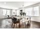 Sunlit condo living and dining area with hardwood floors, contemporary furniture, and large windows at 622 E 10Th St # 212, Indianapolis, IN 46202