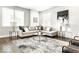 Cozy living room featuring a stylish gray sectional, patterned rug, and plenty of natural light at 622 E 10Th St # 212, Indianapolis, IN 46202