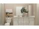 Well-lit bathroom featuring double vanity, white cabinets, a neutral color scheme, and modern decor at 624 Bridgeman Rd, Avon, IN 46123