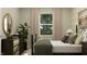 Cozy bedroom features a metal bed frame, a dresser, nightstand, large windows, and modern decor at 624 Bridgeman Rd, Avon, IN 46123