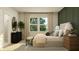 Bright bedroom features a woven bench at the foot of the bed, large windows, black dresser, and modern decor at 624 Bridgeman Rd, Avon, IN 46123