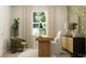 Stylish office features a modern desk, linen chair, green accent chair, and decorative wallpaper at 624 Bridgeman Rd, Avon, IN 46123