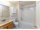 Bright bathroom features a tub and shower combination, vanity with sink, and toilet at 6516 Amherst Way, Zionsville, IN 46077