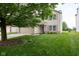 Attractive two-story home with green shutters, lush lawn, and blooming flowerbeds at 6516 Amherst Way, Zionsville, IN 46077