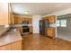 Well-lit kitchen with wooden cabinets, stainless steel appliances, and hardwood flooring at 6516 Amherst Way, Zionsville, IN 46077