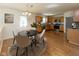Charming eat-in kitchen boasts stainless steel appliances, wooden cabinetry, and hardwood floors at 6516 Amherst Way, Zionsville, IN 46077