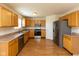 Spacious kitchen with stainless steel appliances, wood cabinets, and laminate countertops at 6516 Amherst Way, Zionsville, IN 46077