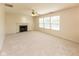 Bright living room featuring a fireplace, ceiling fan, and large windows providing ample natural light at 6516 Amherst Way, Zionsville, IN 46077