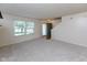Bright living room with neutral carpet, a large window, and staircase access at 6516 Amherst Way, Zionsville, IN 46077