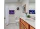 Bright bathroom with wood vanity, white countertop, and decorative accents at 710 Monarch Ln, Lebanon, IN 46052