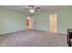 View of a bedroom with light green walls and carpeted floors. Doors lead to other rooms at 710 Monarch Ln, Lebanon, IN 46052