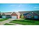 View of a well-maintained brick home with a two-car garage and green lawn at 710 Monarch Ln, Lebanon, IN 46052