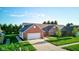 Charming brick home with an attached two-car garage and a well-maintained lawn and landscaping at 710 Monarch Ln, Lebanon, IN 46052