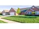 Charming brick home featuring an attached two-car garage and a well-manicured lawn at 710 Monarch Ln, Lebanon, IN 46052