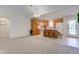 Kitchen open to living room has central island with bar stools, wooden cabinets, and neutral paint at 710 Monarch Ln, Lebanon, IN 46052