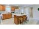 A cozy kitchen with wooden cabinets, white countertops and appliances, and a view to the back door at 710 Monarch Ln, Lebanon, IN 46052