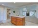 Bright eat-in kitchen featuring an island, white countertops, wooden cabinets and a view into the living room at 710 Monarch Ln, Lebanon, IN 46052