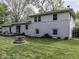Large backyard featuring a deck, fire pit, lush lawn, and plenty of room for outdoor activities at 7216 N Parker Ave, Indianapolis, IN 46240