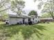 Large backyard featuring a patio, grill, mature trees, and plenty of room for recreation at 7216 N Parker Ave, Indianapolis, IN 46240