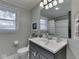 Cozy bathroom featuring a modern vanity, a toilet, and a shower and bath area with tiled walls at 7216 N Parker Ave, Indianapolis, IN 46240