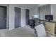 The bedroom is carpeted, has gray walls and two closets; a desk and office chair offer a workspace at 7216 N Parker Ave, Indianapolis, IN 46240