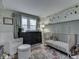 Charming Bedroom featuring a crib, black dresser, neutral-colored walls, and decor creating a calming atmosphere at 7216 N Parker Ave, Indianapolis, IN 46240