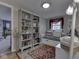 Cozy bedroom with built-in bookshelves, a daybed, wood floors and a decorative rug at 7216 N Parker Ave, Indianapolis, IN 46240