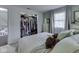 Bedroom featuring a comfortable bed, a window with natural light, and a well-organized closet with ample storage space at 7216 N Parker Ave, Indianapolis, IN 46240