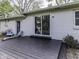 Comfortable deck with sliding glass doors leading into the home and an adjacent backyard door at 7216 N Parker Ave, Indianapolis, IN 46240