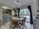 Warm dining space featuring a round table, wooden chairs, and a sliding glass door with backyard views at 7216 N Parker Ave, Indianapolis, IN 46240