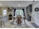 Cozy dining area with a wooden table, chairs, and sliding glass doors leading to the backyard at 7216 N Parker Ave, Indianapolis, IN 46240