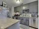 Charming kitchen featuring classic gray cabinetry, stainless steel appliances, mosaic backsplash and a convenient butcher block island at 7216 N Parker Ave, Indianapolis, IN 46240