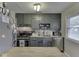 Charming kitchen featuring classic gray cabinetry, stainless steel appliances and a mosaic backsplash at 7216 N Parker Ave, Indianapolis, IN 46240