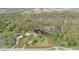 Aerial shot of property outlining a home with a pond, surrounded by mature trees and lush greenery at 7310 W 100 N, Greenfield, IN 46140