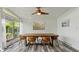 Bright dining room features modern table set, unique light fixture, and large windows overlooking green scenery at 7310 W 100 N, Greenfield, IN 46140