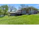Backyard view of a modern gray house with walkout deck overlooking a pond at 7310 W 100 N, Greenfield, IN 46140