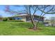Well-maintained home featuring a gray facade, stone accents, and a beautifully landscaped front yard with mature trees at 7310 W 100 N, Greenfield, IN 46140