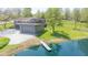 Aerial view of a modern home with lake frontage, offering stunning water views and outdoor enjoyment at 7310 W 100 N, Greenfield, IN 46140