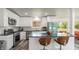 Modern kitchen featuring sleek white cabinetry, stainless steel appliances, and barstool seating at the island at 7310 W 100 N, Greenfield, IN 46140