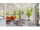 Bright living room featuring large windows, wood floors, and stylish mid-century modern furniture at 7310 W 100 N, Greenfield, IN 46140