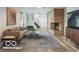 This staged living room includes stairs, a brick fireplace and a large patterned rug at 7310 W 100 N, Greenfield, IN 46140