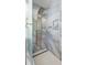 Modern shower features floor-to-ceiling stone-look tile and a unique multi-setting shower panel at 7310 W 100 N, Greenfield, IN 46140