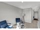 Living room featuring plush chairs, a glass coffee table, and neutral walls at 7645 Marin Pkwy, Cumberland, IN 46229