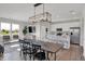 Open-concept living space with modern lighting, dining area, and bright kitchen at 7645 Marin Pkwy, Cumberland, IN 46229