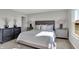 Well-lit bedroom with a large bed, side tables, and stylish decor with outside views at 7651 Marin Pkwy, Cumberland, IN 46229