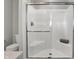 Modern bathroom with a clear glass-enclosed shower, toilet, and neutral color scheme at 7651 Marin Pkwy, Cumberland, IN 46229
