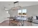 Stylish dining space with wood floors, a modern chandelier, and comfortable seating at 7657 Marin Pkwy, Cumberland, IN 46229