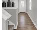 Bright foyer featuring wood floors, neutral walls, and a staircase leading to the upper level at 7657 Marin Pkwy, Cumberland, IN 46229